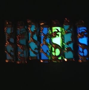 7 glow in the dark synthetic crystals encased by a golden dragon pendants..25002